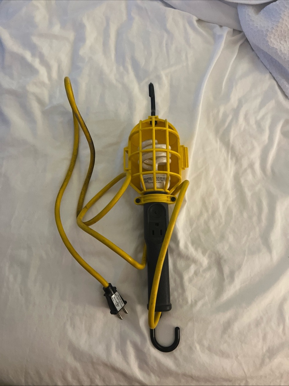 Portable Yellow Work Light with Built-In Outlet